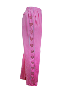 Pink pants with heart patterns on a white background